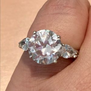 Synthetic 4 carat stunner Garnished w/side stones!